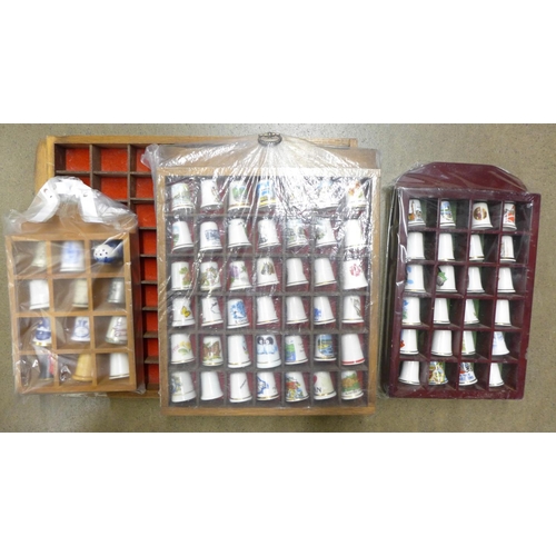 1247 - Eighty-two ceramic thimbles and four display racks