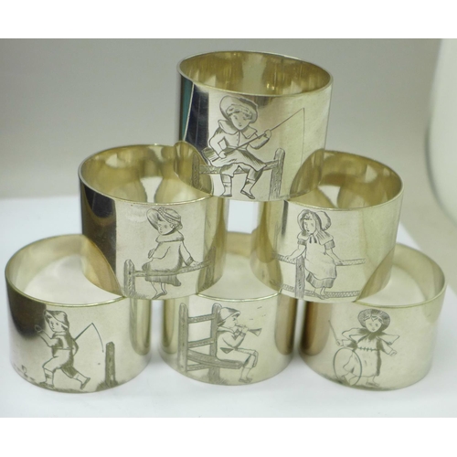 634 - A cased set of six napkin rings with etched figures of a Victorian girl and boy