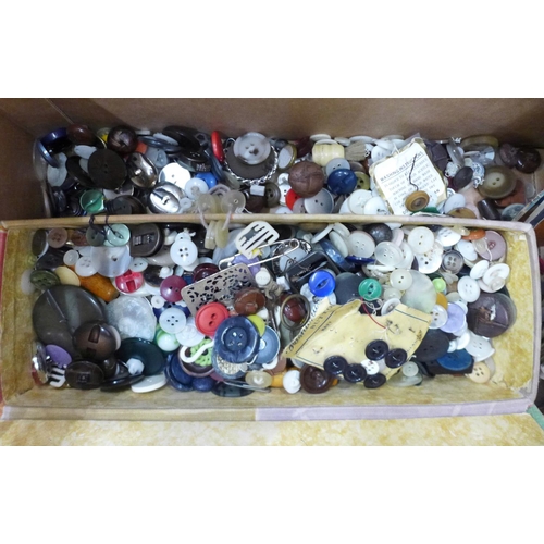 739 - Haberdashery including a box and tub of buttons, some on cards, buckles, cotton reels, knitting patt... 