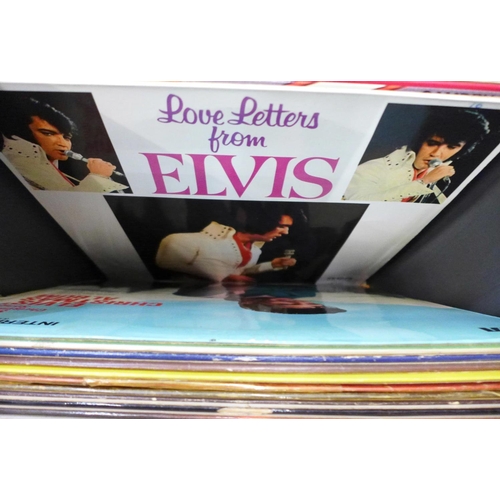 743 - Elvis, a collection of LP records, CD singles box set and a tin with book and nine magnet set