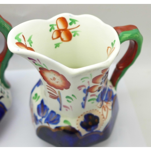 758 - A group of three graduated hand painted jugs decorated in the Gaudy Welsh style, circa 1920, 10cm to... 