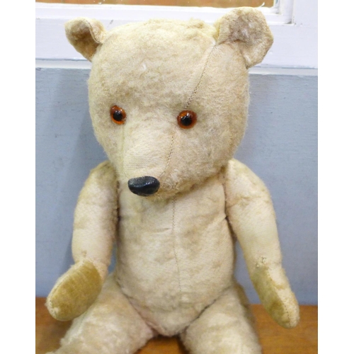 780 - A straw filled jointed Chiltern Teddy bear with working musical box, winder situated on his back, pl... 