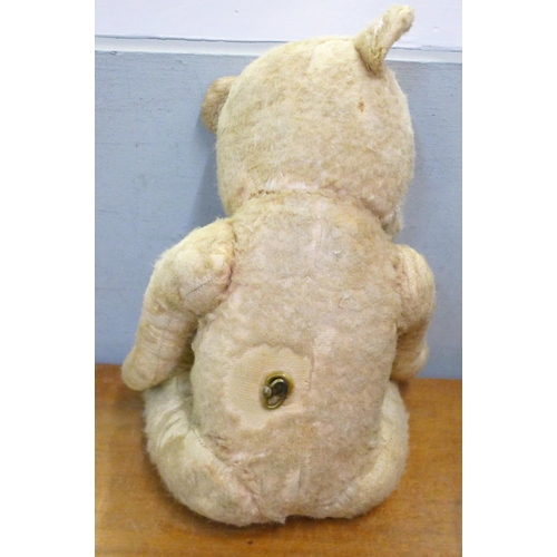 780 - A straw filled jointed Chiltern Teddy bear with working musical box, winder situated on his back, pl... 