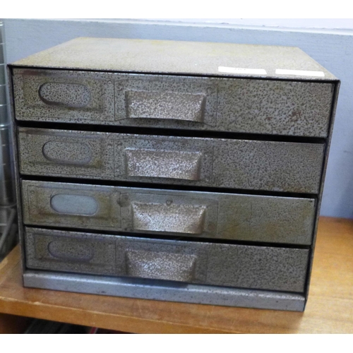 781 - A metal four drawer cabinet of pocket watch parts