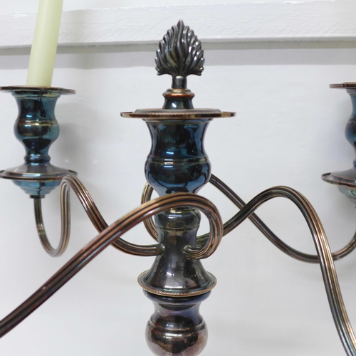 821 - A silver plate on copper four branch candelabra