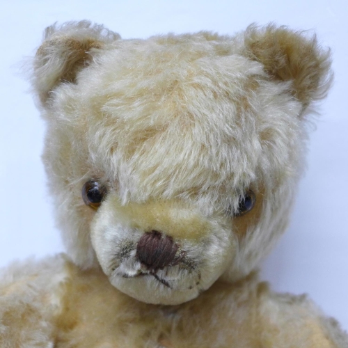 831 - A large Schuco Teddy bear, circa 1930's, straw filled with jointed limbs, glass eyes and tail, 50cm