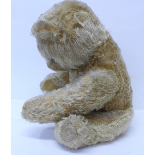 831 - A large Schuco Teddy bear, circa 1930's, straw filled with jointed limbs, glass eyes and tail, 50cm