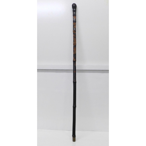 840 - A Japanese ebonised bamboo walking cane, root finial, with finely carved decoration of two snakes, a... 