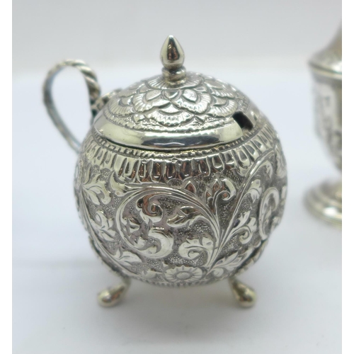 856 - A pair of Victorian silver pepper pots by George Unite and a white metal mustard pot, lid loose, hin... 