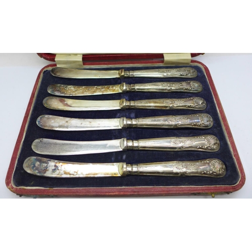 880 - A cased set of six silver handled knives, six silver commemorative spoons, a silver holder and two n... 