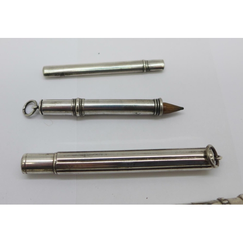 921 - Four silver pencil holders including one Victorian and one larger white metal pencil holder, (tests ... 