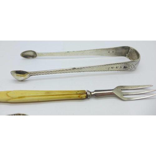 943 - A pair of Georgian silver sugar bows, a silver sugar spoon and a silver and ivory handled pastry for... 