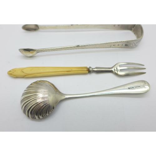 943 - A pair of Georgian silver sugar bows, a silver sugar spoon and a silver and ivory handled pastry for... 