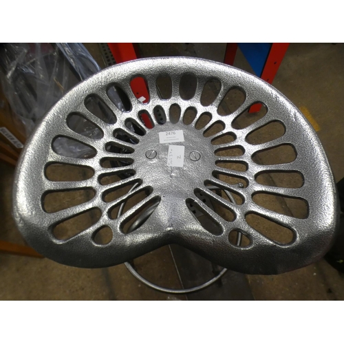 2435 - 2 Cast metal tractor style stools * This lot is subject to VAT