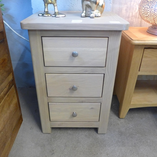 1363 - A Chichester three drawer bedside chest,marks to front edge.