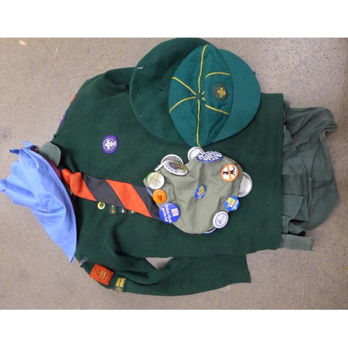 1202 - A cub scout jumper with award badges, shirt, belt, beret, and another cap with pin badges