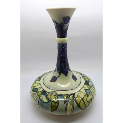 611 - A Moorcroft Juneberry vase, designed by Angela Davenport, signed on the base, 24cm, boxed