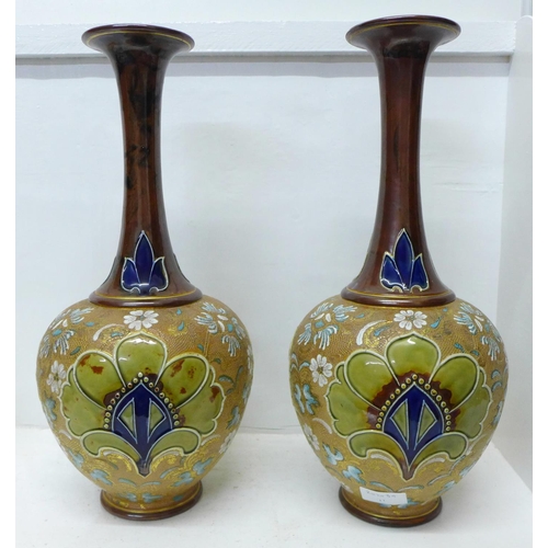 617 - A pair of Royal Doulton Slater's Patent stoneware vases with long flared necks, 40cm