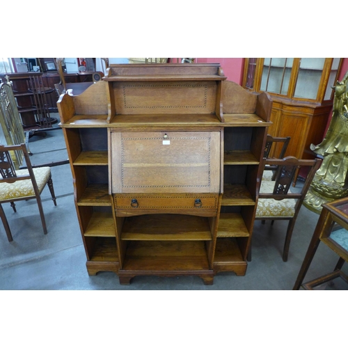 127 - An Arts and Crafts inlaid oak bureau bookcase
