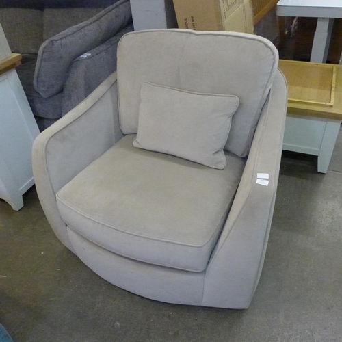 1554 - A taupe velvet swivel armchair