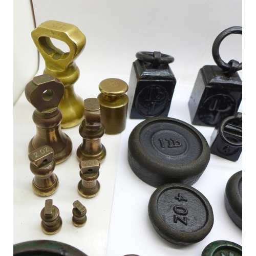 696 - A collection of weights including bell weights and smaller balance scale weights