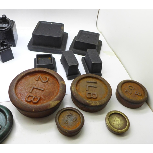 696 - A collection of weights including bell weights and smaller balance scale weights