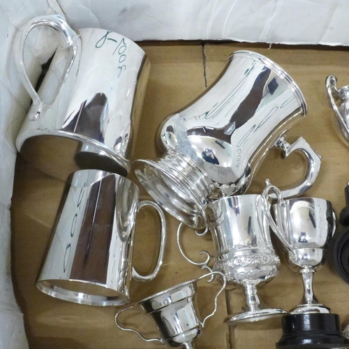 724 - A box of silver plated items, rose bowl, four trophies, three piece tea service, tankards, etc.