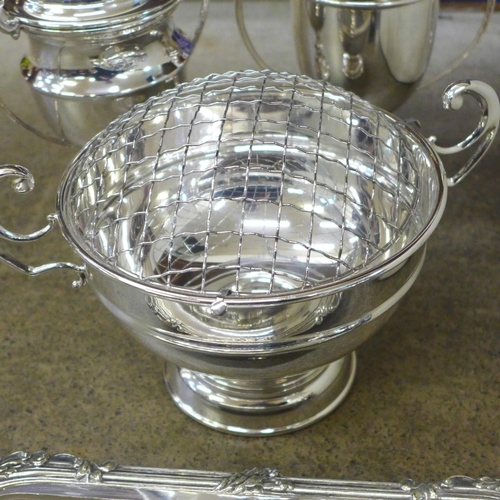 724 - A box of silver plated items, rose bowl, four trophies, three piece tea service, tankards, etc.