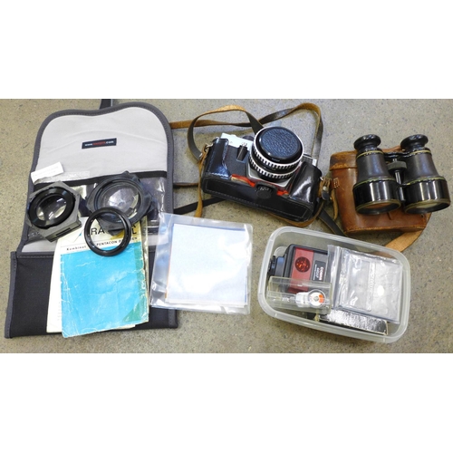 737 - A Praktica LB film camera, with instructions and filters set, a box of Canon flash accessories and a... 