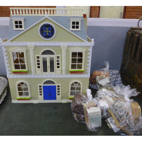 781 - A large plastic doll's house with furniture