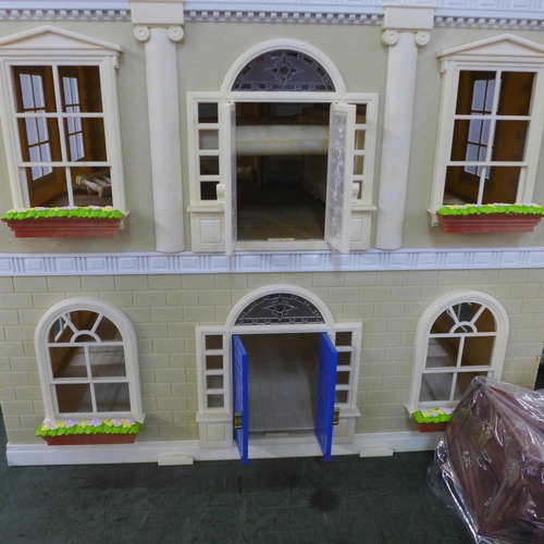 781 - A large plastic doll's house with furniture