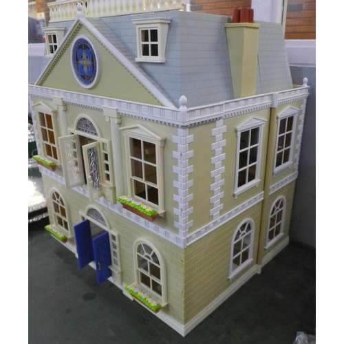 781 - A large plastic doll's house with furniture