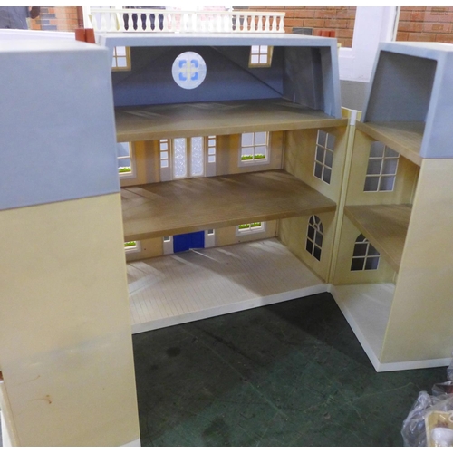 781 - A large plastic doll's house with furniture