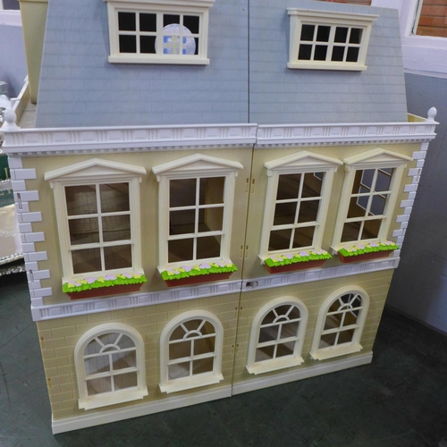 781 - A large plastic doll's house with furniture