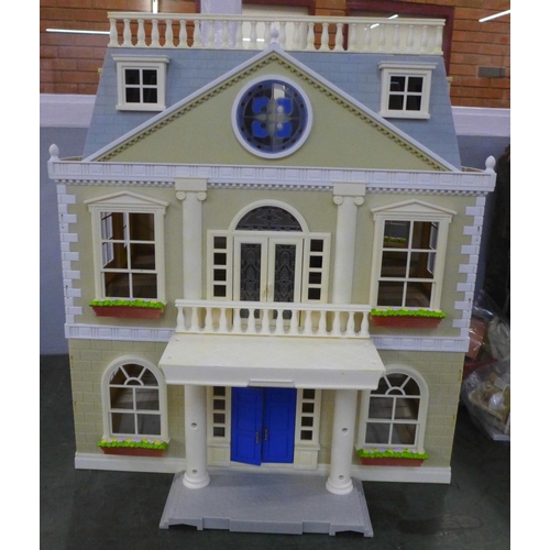 781 - A large plastic doll's house with furniture