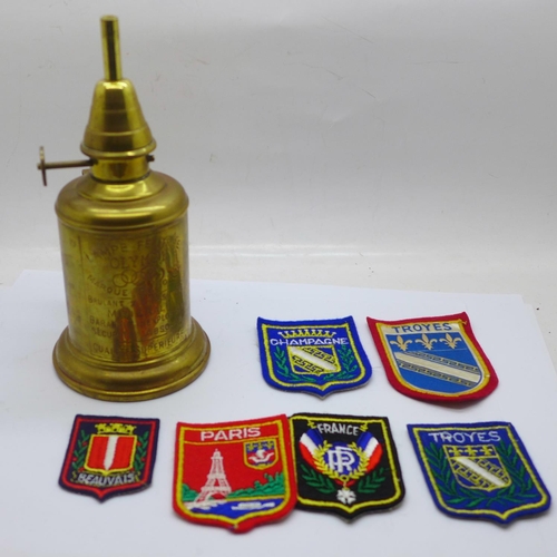 788 - A French brass pigeon lamp and French cloth badges