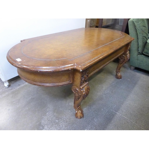 1780 - A coffee table with faux leather top and ball and claw feet