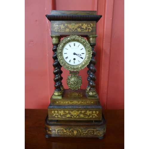 123 - A 19th Century French inlaid rosewood portico clock, with turned barleytwist columns, the enamel dia... 