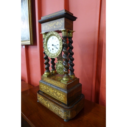 123 - A 19th Century French inlaid rosewood portico clock, with turned barleytwist columns, the enamel dia... 