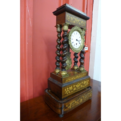 123 - A 19th Century French inlaid rosewood portico clock, with turned barleytwist columns, the enamel dia... 