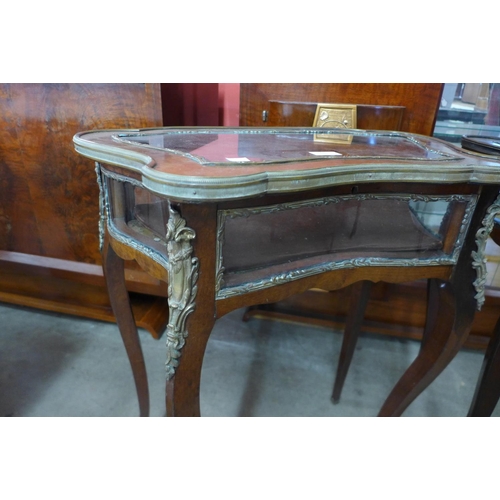 124 - A pair of French Louis XV style mahogany and gilt metal bijouterie tables