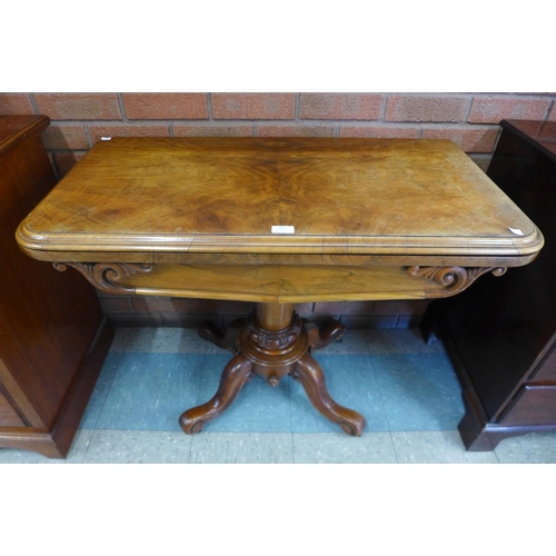 135 - A Victorian walnut fold over card table