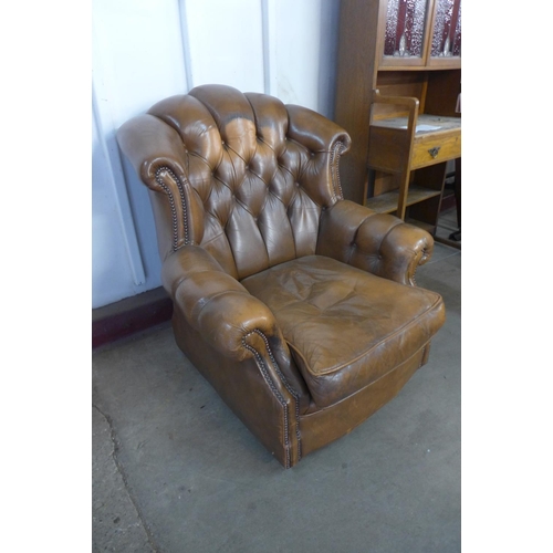 139A - A brown button back leather armchair