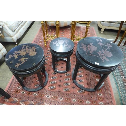 142 - A Chinese black lacquered chinoiserie circular nest of tables