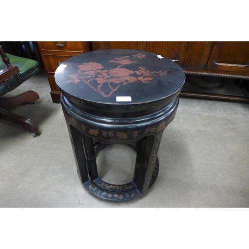 143 - A Chinese black lacquered chinoiserie circular nest of tables