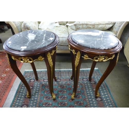 145 - A pair of French Louis XV style mahogany parcel gilt and marble topped circular jardiniere stands