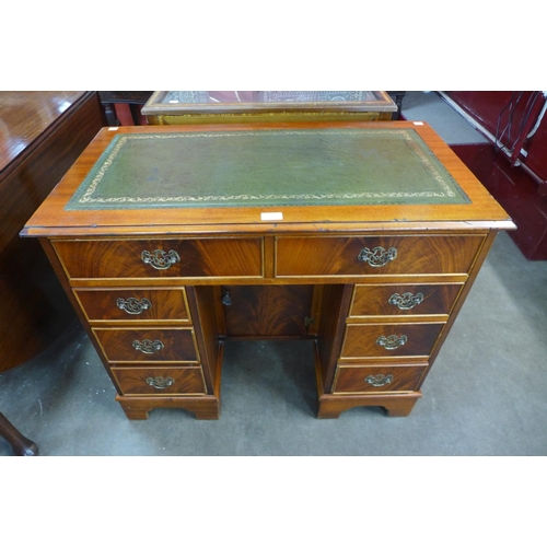 156 - A George II style mahogany and green leather kneehole desk