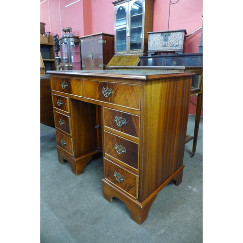 156 - A George II style mahogany and green leather kneehole desk