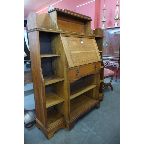 159 - An Arts and Crafts inlaid oak bureau bookcase