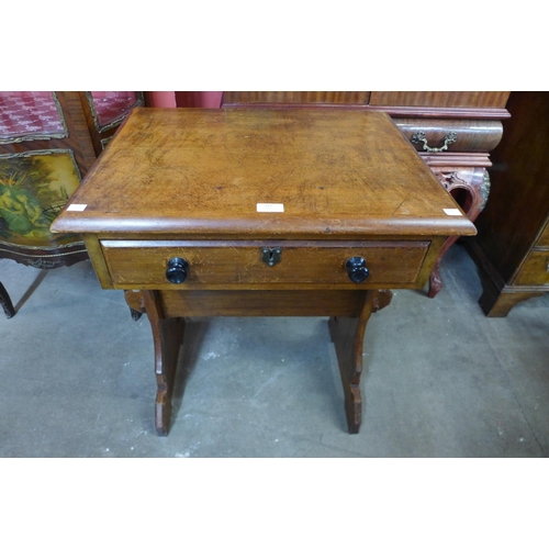 162 - A Victorian Gothic Revival pine and walnut single drawer side table